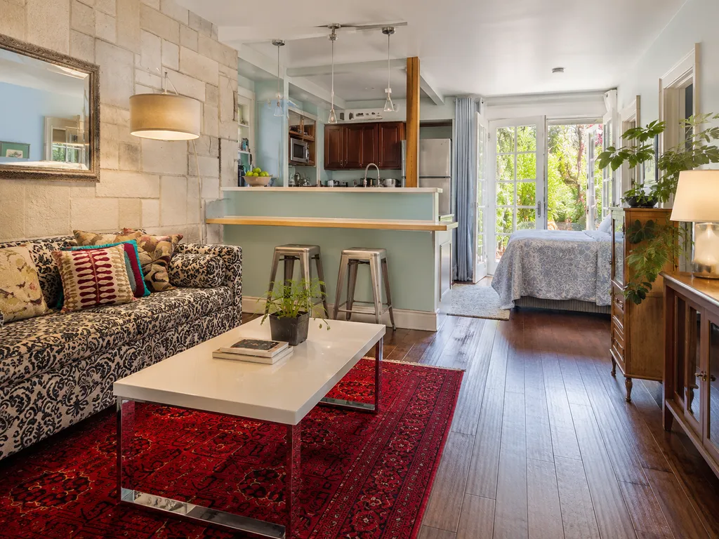 Living room with a couch, coffee table, and a kitchen island.